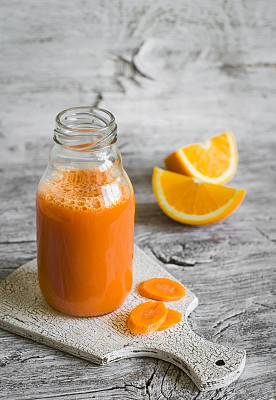 fresh carrot-orange juice in a glass bottle