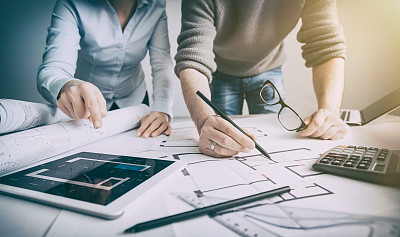 Designers discuss the sketches inside the house.