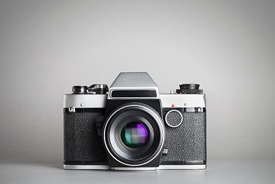 Retro camera on grey background