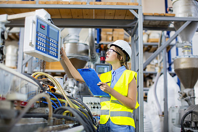 Young female engineer controlling the production