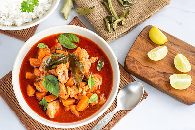 Thai Red Chicken Curry in a Bowl Served with Rice and Lemon Directly Above