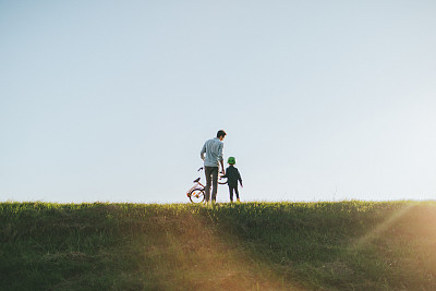 Father and son on a bicycle lane