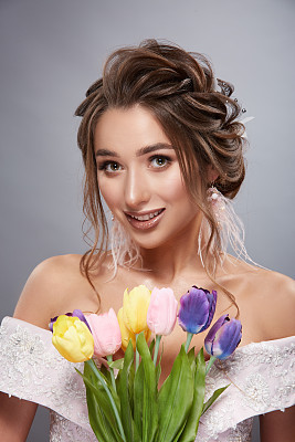 pretty bride smilling with colorful flowers