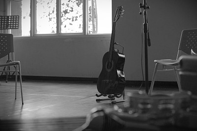 acoustic guitar standing in empty room
