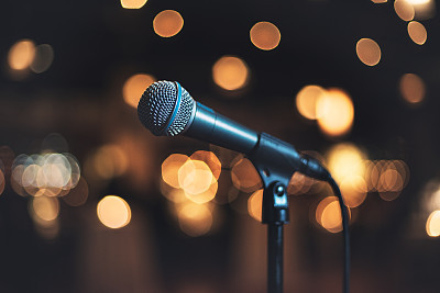 Microphone on stage against a background concert or show