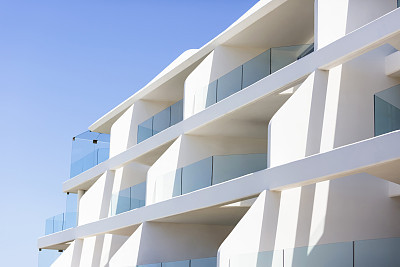 Closeup modern apartment building against blue sky, copy space
