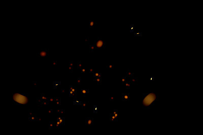 blurred sparks from fire in front of black backgound