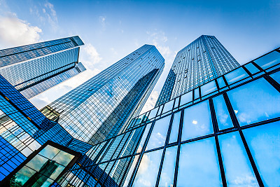 Modern skyscrapers in business district against blue sky