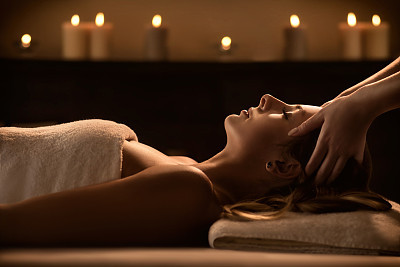 Young woman enjoys massage in a luxury spa resort