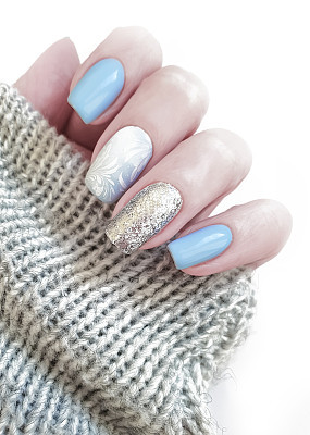 female hand manicure, sweater