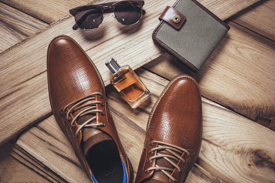 Men's accessories organized on wooden table