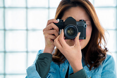 Portrait of a woman taking a photo