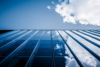 Clouds reflected in windows of modern office building