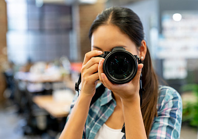 Asian photographer shooting indoors