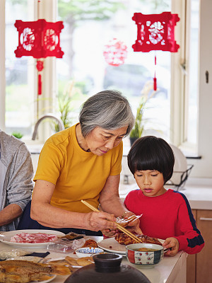 Chinese Multi-Generation Family Preparing New Year Food in a Kitchen