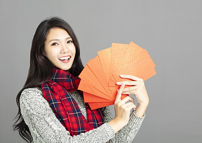 asian woman showing red envelopes for chinese new year