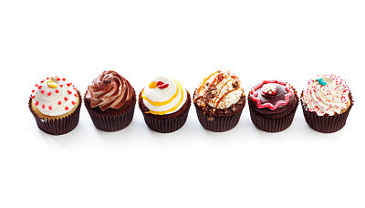 Fancy Gourmet Cupcakes, Dessert Temptations in Row on White Backround