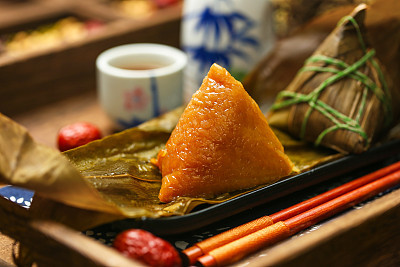 Chinese dragon boat festival rice dumplings zongzi and wine on black plate