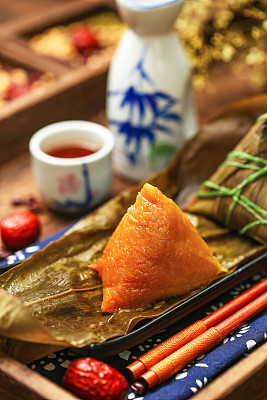 Chinese dragon boat festival rice dumplings zongzi and wine on black plate