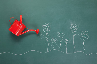 Red Watering Can And Flowers Drawings On Blackboard
