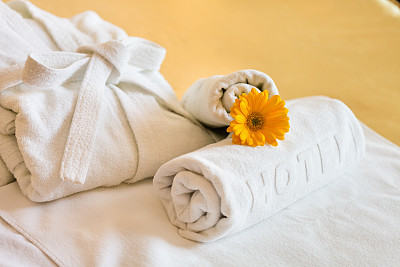 Towels and bathrobe in hotel room