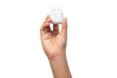 White wireless earphones in-ear or earbud Bluetooth with charging case holding in hand isolated on white background.