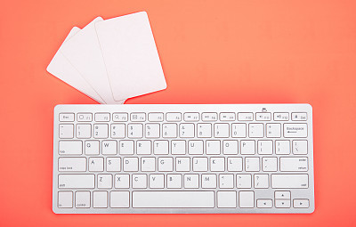 Computer keyboard on orange background