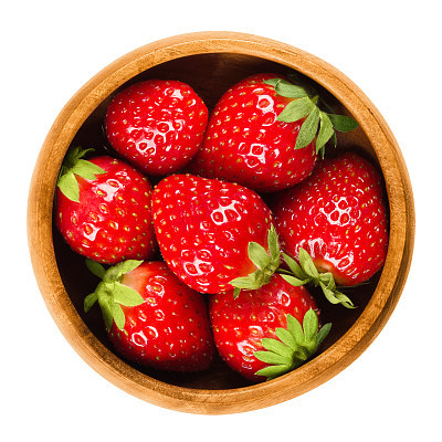 Garden Strawberries in wooden bowl on white background