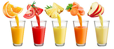 Fresh juice pours from fruit and vegetables into the glass isolated on white background.