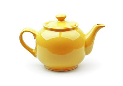 A shiny yellow teapot on a white background
