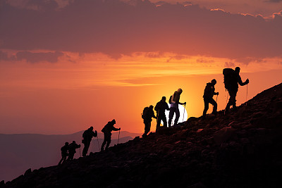 Hikers Silhouetted At Sunset