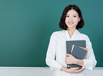 Female teacher in front of chalkboard
