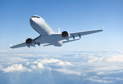 Passenger jet airplane flying above clouds