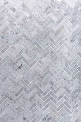 Background of grey and white marble tile in herringbone pattern