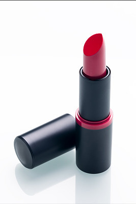 open red lipstick with cap on white background with shadow