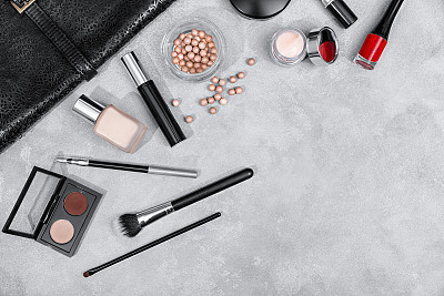 Frame from set of professional decorative cosmetics, makeup tools and accessory on concrete gray background copy space for your text. flat lay frame composition, top view