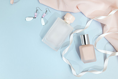 Frame from set of professional decorative cosmetics, makeup tools and accessory on blue background copy space for your text. flat lay frame composition, top view