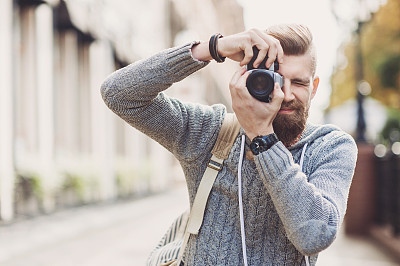Young man photographer looking at camera