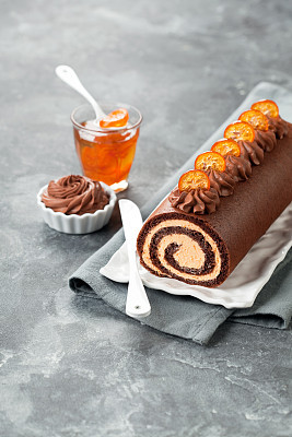 Chocolate swiss roll cake with candied kumquats