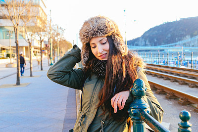 Winter fashion portrait of a young woman in the city