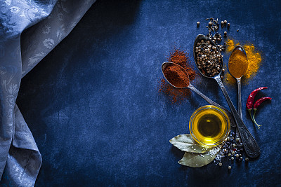 Spices background on bluish tint kitchen table