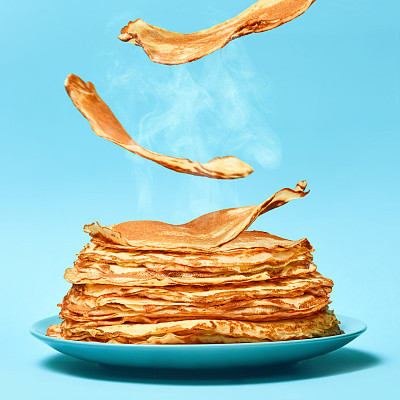 French pancakes is flying on the blue background