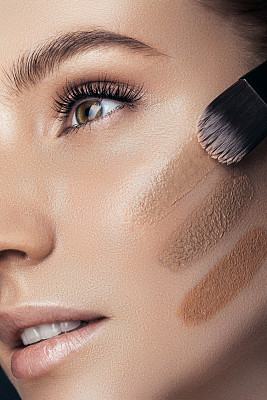 Woman applying tone cream