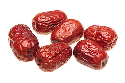 Dry red jujubes   on white background