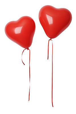 Two red heart shape balloons with ribbon against white background
