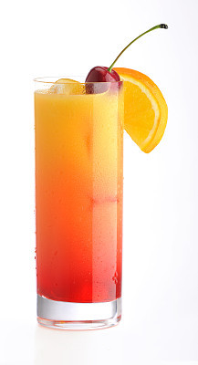 Classic Tequila Sunrise cocktail with cherry & orange slice on ice