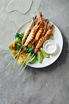 Tandoori prawn skewers with lime yoghurt dressing and roti