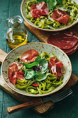 Spinach pasta with basil pesto and prosciutto