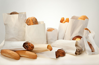 Still life. Bread with different additives with seeds, sesame seeds, cheese, cottage cheese, poppy seeds packed in paper bags.