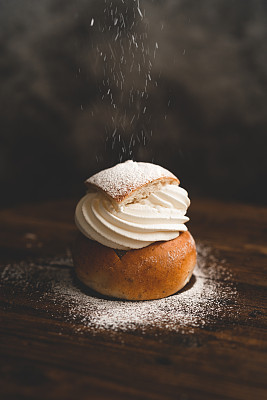 Traditional Swedish dessert Semla with whipped cream and sugar